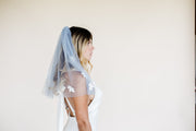 Short blue blusher wedding veil with flower applique daisy