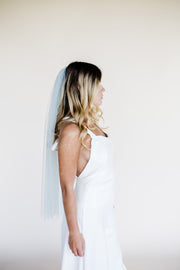 Waist length blue modern wedding veil with mother of pearl heart embellishment